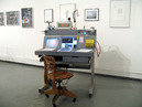Exhibition View BPL Brower Propulsion Laboratory: Steven Brower, Parker's Box, 2007.

Portable Mission Control Console, 2007, aluminum, plastic, and wood console with computers, television, telephone, modem, printer, clock, special Carl Sagan lamp, cup holder, cameras, radio equipment, and napkins, 46