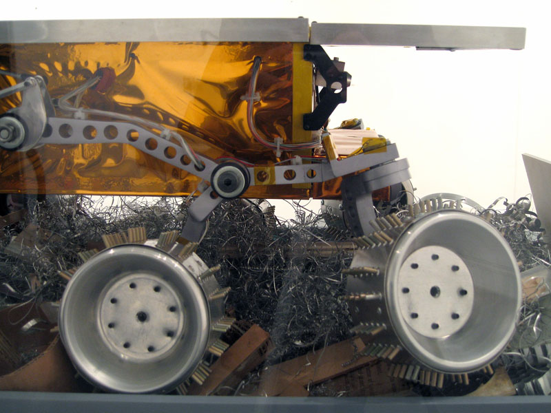 Limited Intelligence Marginally Produced Exploration Rover (LIMPER)
2007, aluminum, urethane, acrylic, mylar, cardboard, paper, Kapton, electronics, 12 3/4 x 31 x 21 inches (32 x 79 x 53 cm)
Front right detail showing Rocky Booger Suspension.