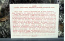 Informational placard on front of LIMPER display case.  LIMPER is presented on a bed of discarded material associated with its manufacture.